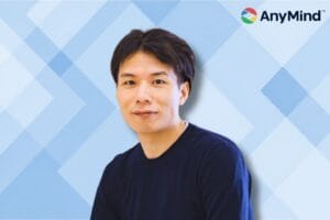 AnyMind CEO with logo images and geometric blue background