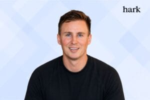 Hark founder and logo image with light blue geometric background