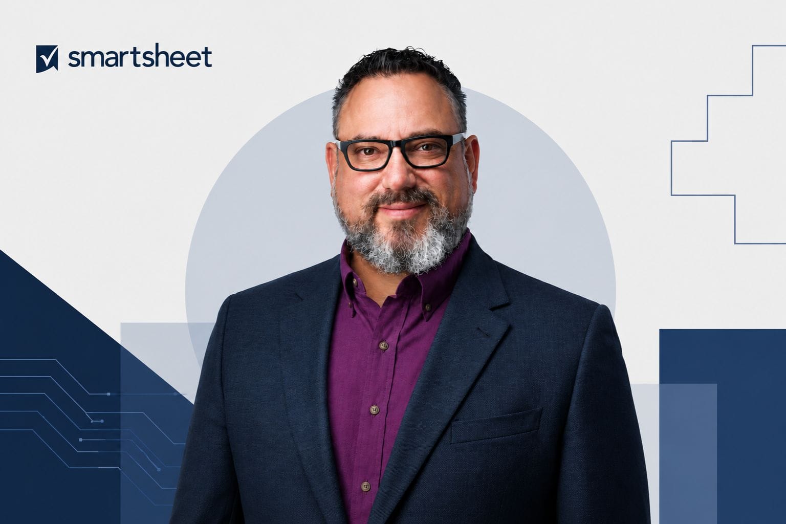 Portrait of Drew Garner, Smartsheet’s first Chief AI Officer, in a navy blazer and purple shirt against a subtle geometric corporate background with the Smartsheet logo.