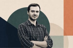 Editorial portrait of Andrej Karpathy, OpenAI co-founder, set against an abstract geometric background after joining Anthropic.