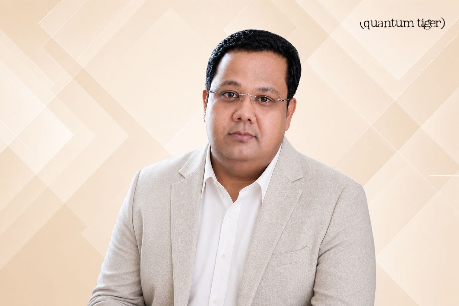 Rana Dutta, CEO and co-founder of Quantum Tiger portrait image with company logo an beige geometric background