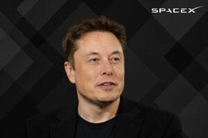 Portrait of Elon Musk against a dark geometric background with the SpaceX logo in the top corner