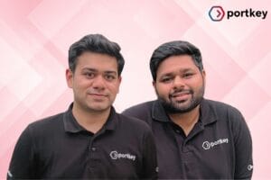 Portkey founders and logo images with pink geometric background