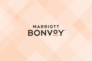 Marriott bonvoy logo on a peach geometric design