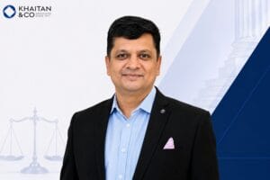 Image of Dr. Vimal Choudhary, COO, Khaitan and Co., and company logo with geometric background