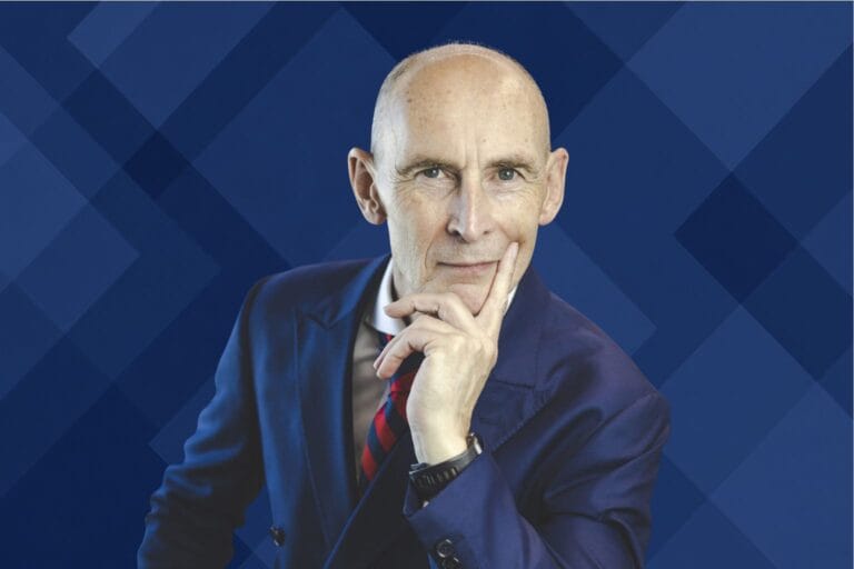 Nigel Green portrait on a deep blue geometric pattern background